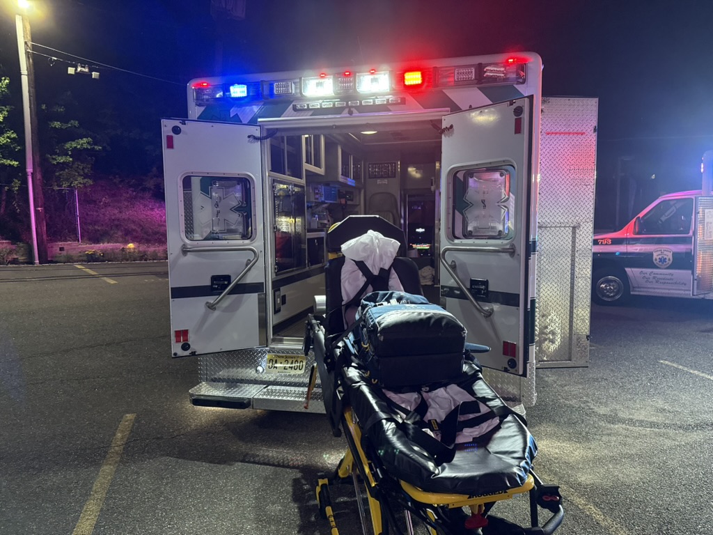 Stretcher staged at the rear of an ambulance.