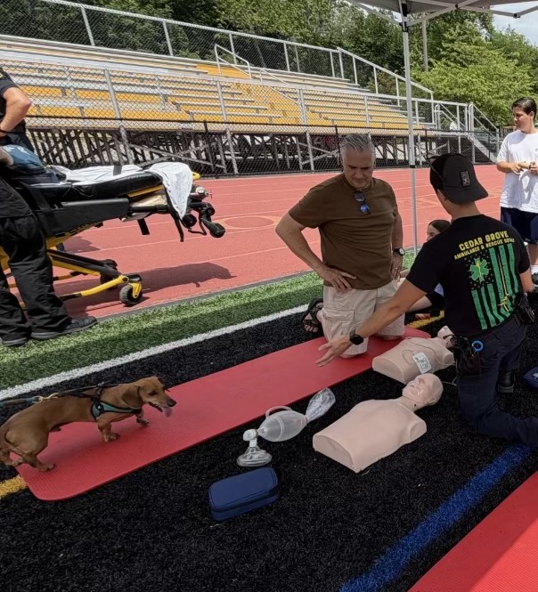 CPR training with community participants at an outdoor track