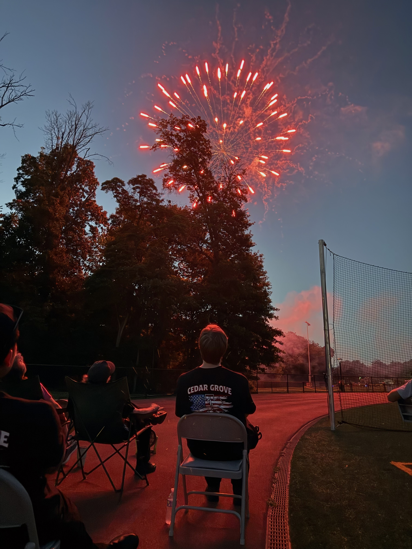 Fireworks over Cedar Grove community standby members seated near the field