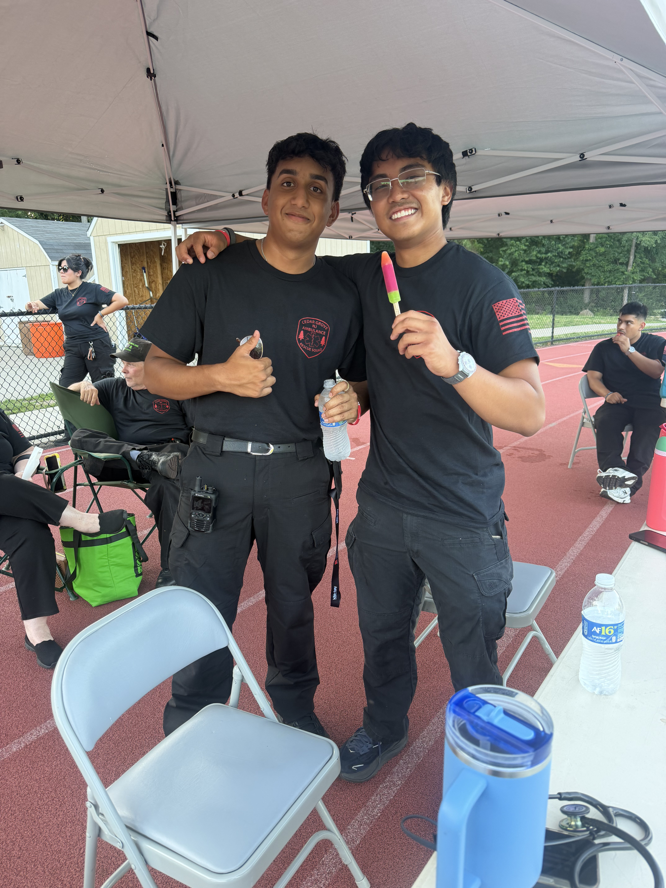 Two Cedar Grove EMS members under a standby tent during a Fourth of July event