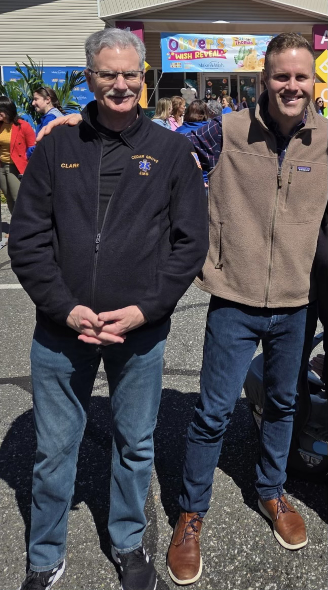 Cedar Grove EMS member standing with a community leader at a public event