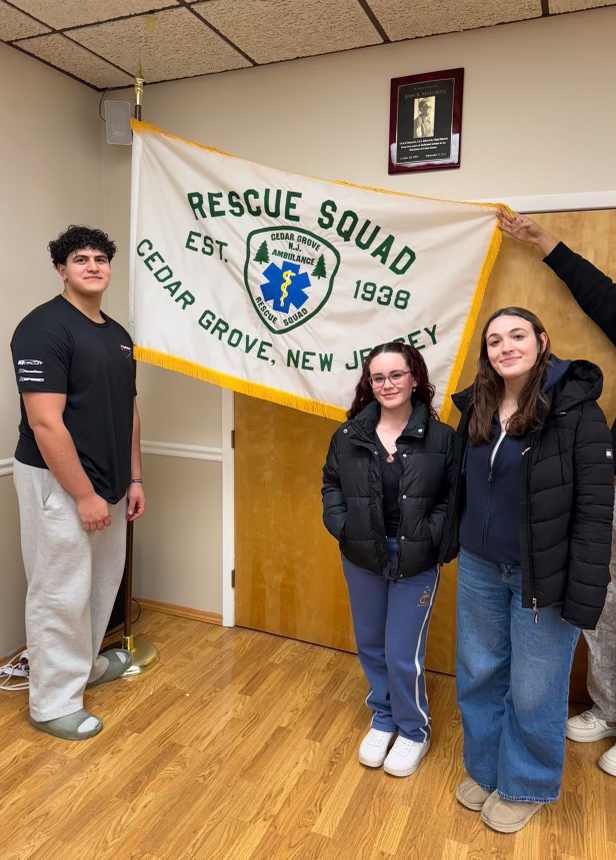 Members standing with the Cedar Grove Rescue Squad flag