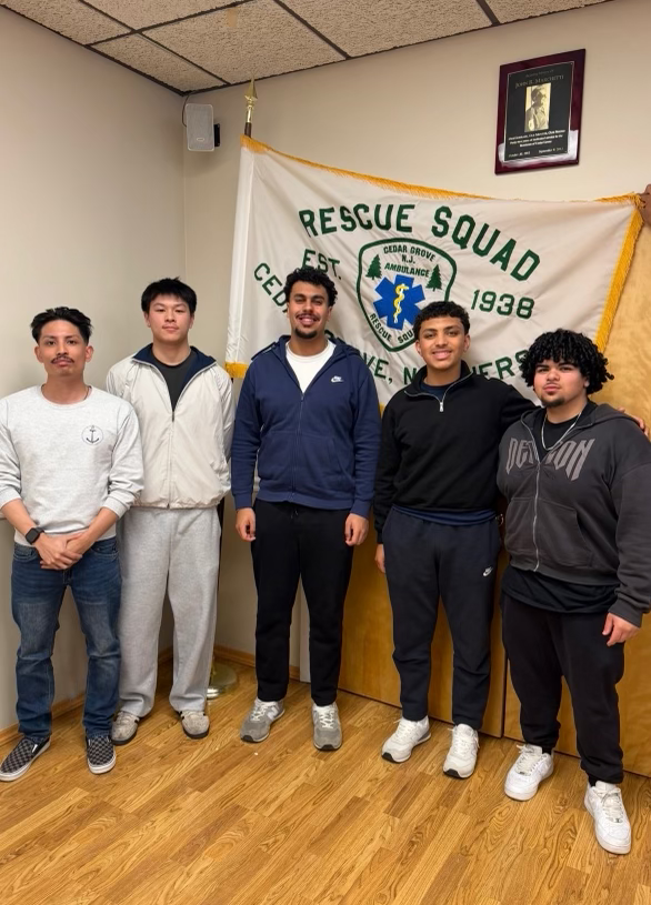 Members standing with a Cedar Grove Rescue Squad flag