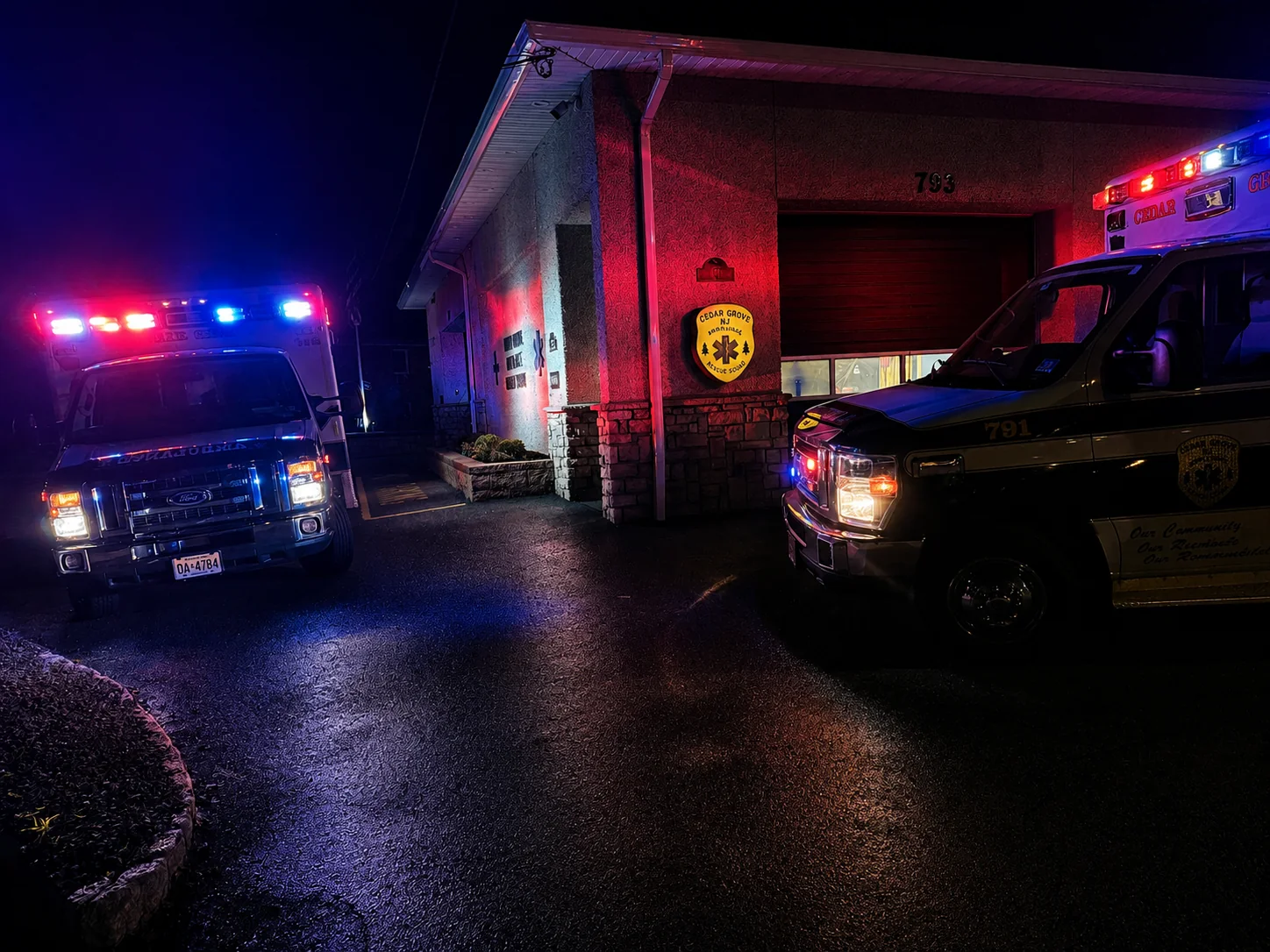 Cedar Grove ambulances outside the squad building at night