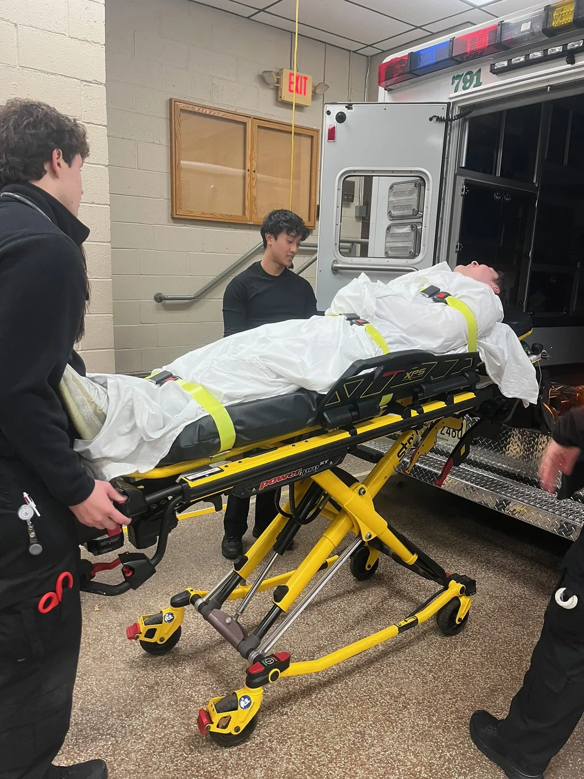 Members practicing patient movement and ambulance loading.