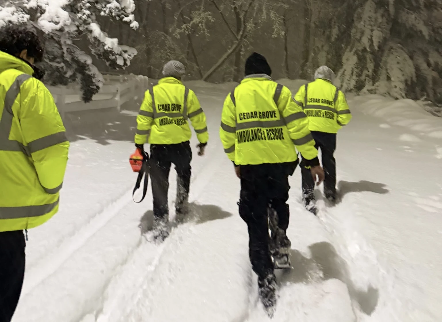 Cedar Grove Ambulance and Rescue Squad members walking through deep snow